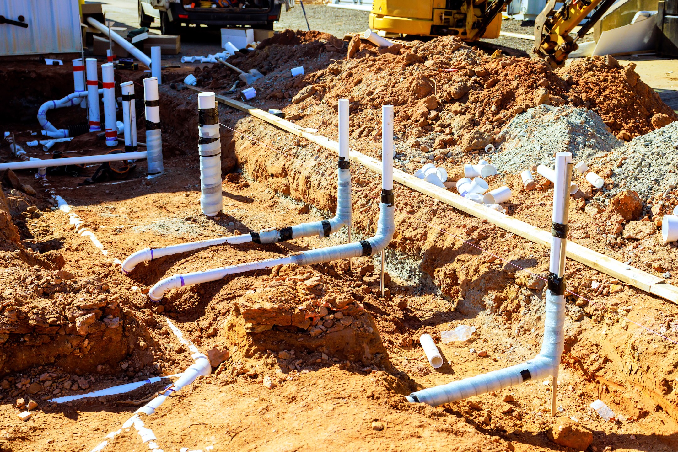 Workers are installing plumbing drainage pipes