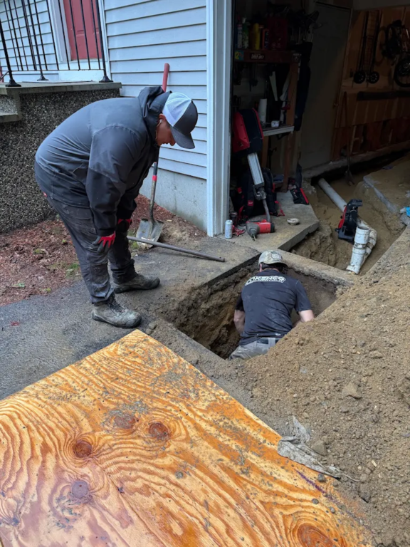 kenco workers clearing sewer line pipe