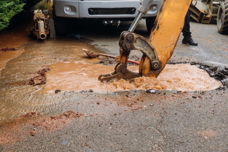 Splatter of water from broken pipe the main road water leaking from hole