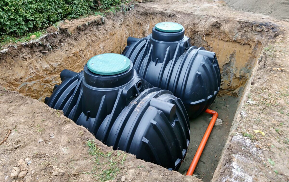 septic vs sewer Two plastic underground storage tanks placed below ground for harvesting a rainwater.