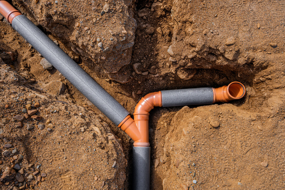 how does a sewer system work laying of sewer pipes. weaving several pipes into one. view from above